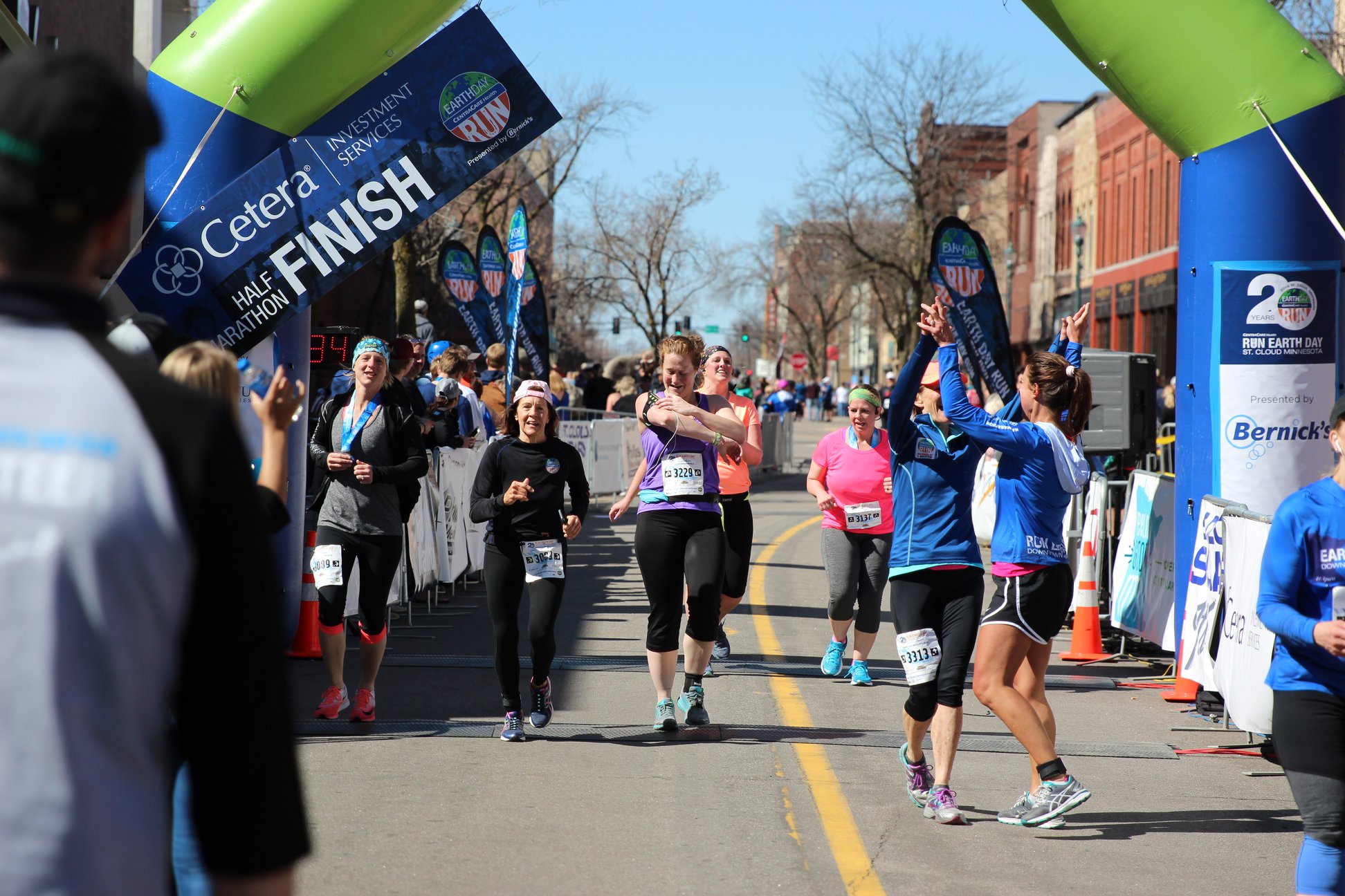 Runners cross the finish line at Earth Day Run in St. Cloud, Minnesota